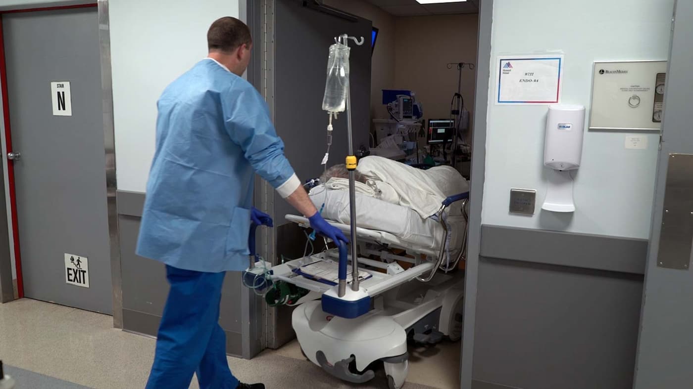 The patient is wheeled into the endoscopy suite where he will be sedated for the procedure. 